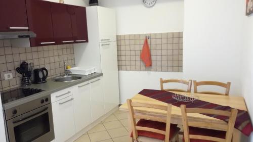 a small kitchen with a table and chairs in it at Apartment Možina in Koper