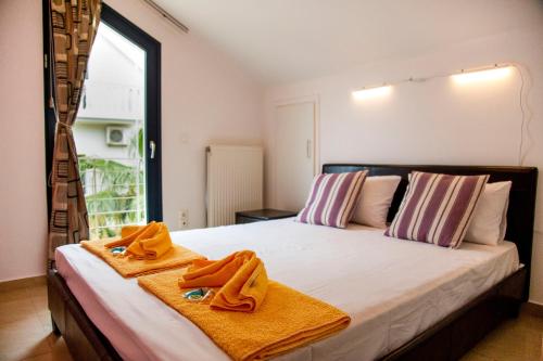 a bedroom with a bed with towels on it at Sophia Central Loft & Apartments in Argostoli
