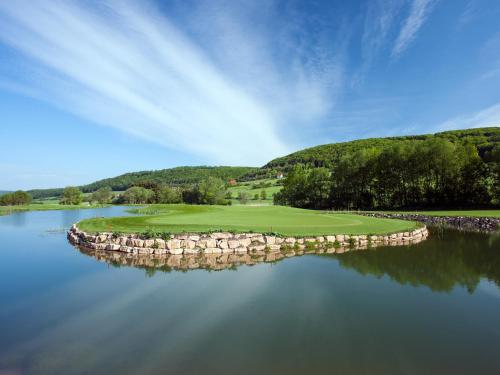 a golf course in the middle of a body of water at Spa & GolfResort Weimarer Land in Blankenhain