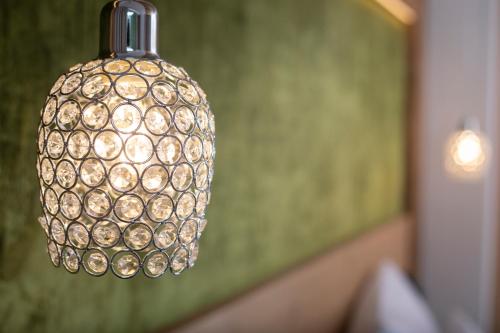 aendant light hanging from the ceiling in a room at Wagner's Aparthotel in Pertisau