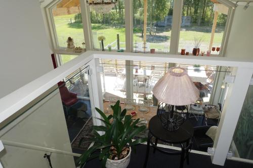 a view of a living room with a table and a lamp at Annexet på Stallbackens Gård in Ås