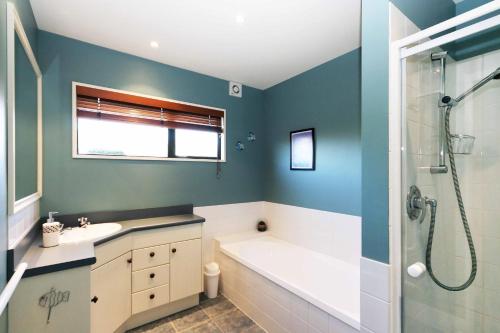 a bathroom with a tub and a sink and a shower at Rifugio - Lake Tekapo in Lake Tekapo