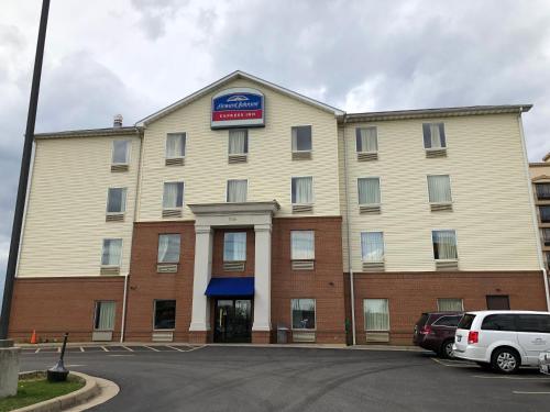 a large building with a sign on top of it at Howard Johnson by Wyndham Airport in Louisville