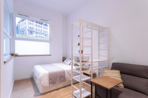 a living room with a bed and a book shelf at GETARIA APARTAMENTUAK - Sahatsaga in Getaria