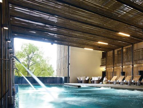 a swimming pool with a fountain in a building at Hotel Maya Kuala Lumpur City Centre in Kuala Lumpur