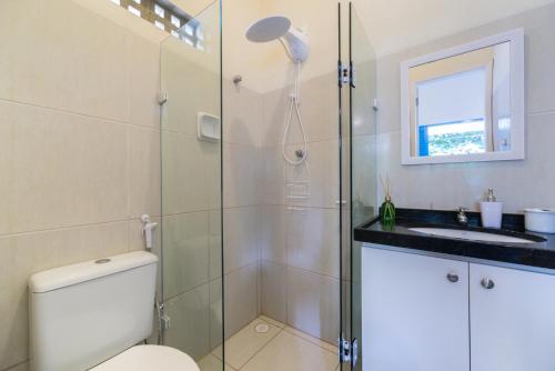 a bathroom with a shower and a toilet and a sink at Casa Azul Home Stay in Porto De Galinhas