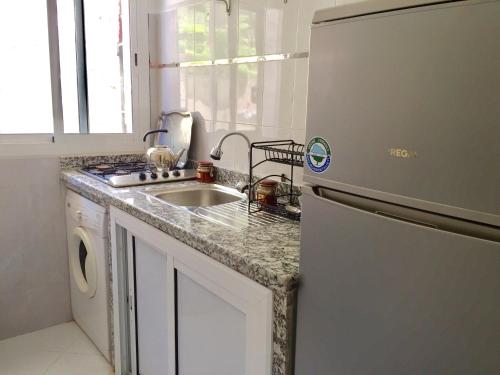 a kitchen with a sink and a refrigerator at Furnished apartments Family only in Tangier