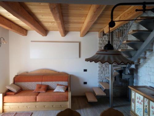a bedroom with a bed in a room with a staircase at Regensburgerhof in Castello Tesino