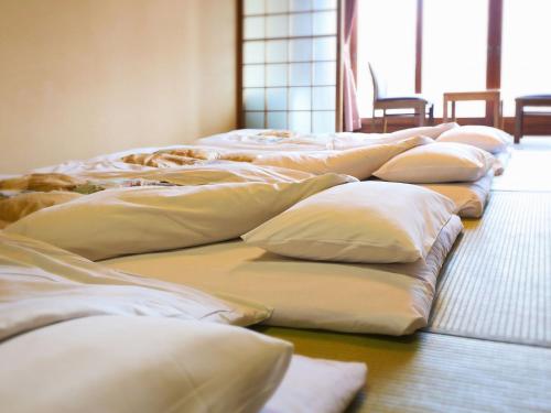 a row of white pillows lined up in a room at APA Hotel Sapporo Susukino Ekinishi in Sapporo