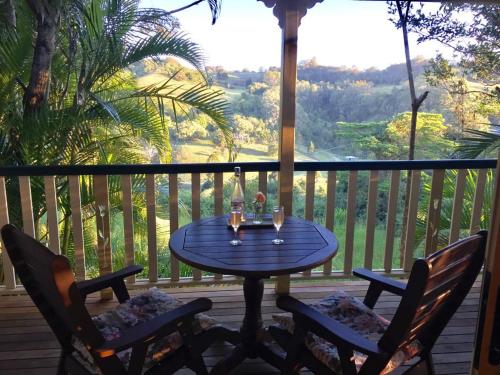 a table and two chairs on a porch with a view at The Falls Montville in Montville