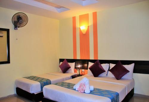 Ένα ή περισσότερα κρεβάτια σε δωμάτιο στο Sun Inns Hotel KopKastam Kelana Jaya