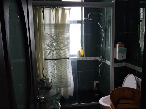 a bathroom with a shower with a window and a toilet at Yi Ju Homestay-ZhuanQiao Subway Station, MinHang District in Shanghai