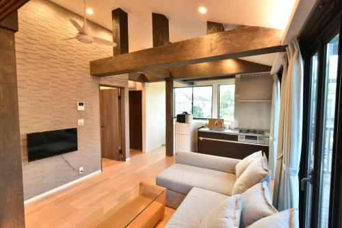 a living room with a couch and a tv at KandoStay 浅草EASTテラス in Tokyo