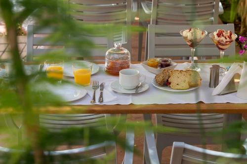a table with a breakfast of coffee and bread and orange juice at Familia in Vathi, Ithaka