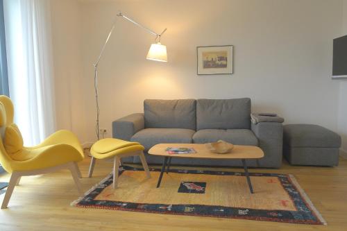 a living room with a couch and a table at Tor zum Meer in Helgoland