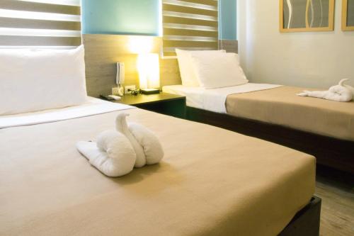 Postel nebo postele na pokoji v ubytování Sheridan Boutique Hotel