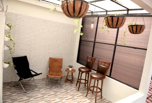 a group of chairs and tables on a patio at Huning House - 5 Bedrooms in Purwokerto