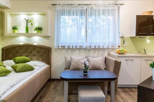 a bedroom with a bed and a table and a chair at Apartament Krupowki CENTRUM in Zakopane