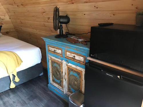 a bedroom with a bed and a dresser with a television at BIG4 Yarra Valley Park Lane Holiday Park in Healesville