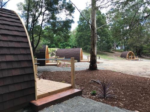 a wooden bench next to a tree in a park at BIG4 Yarra Valley Park Lane Holiday Park in Healesville