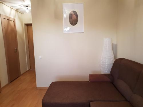 a living room with a couch and a picture on the wall at Scandi FoRest in Palanga