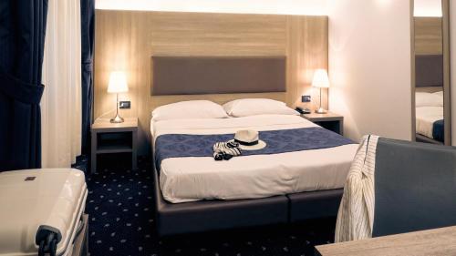 Ένα ή περισσότερα κρεβάτια σε δωμάτιο στο Hotel Roberta