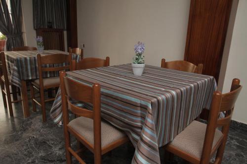 a table with chairs and a table cloth at Evans Hotel in Heraklio