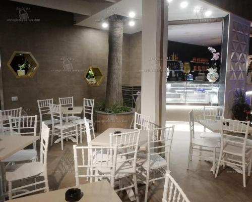 a dining room with white chairs and tables and a table and chairsktop at Hotel Bellavista in Marina di Varcaturo