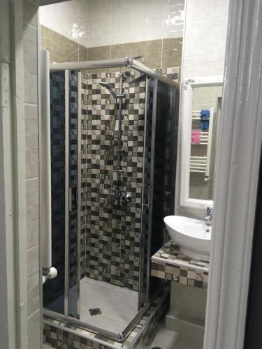 a bathroom with a shower and a sink at Sweet Home Freedom Square in Tbilisi City