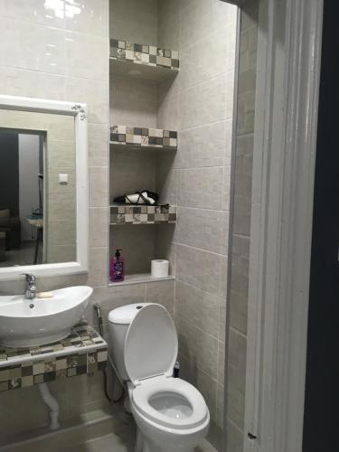 a bathroom with a toilet and a sink at Sweet Home Freedom Square in Tbilisi City