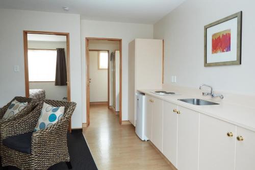 a kitchen with a sink and a counter top at Admiral Court Motel & Apartments in Invercargill