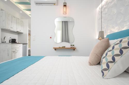 a bedroom with a bed with blue and white at 3 Wishes in Naxos Chora