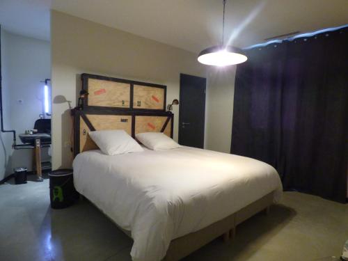 a bedroom with a large white bed in a room at D'OR Les Anges in Les Angles Gard