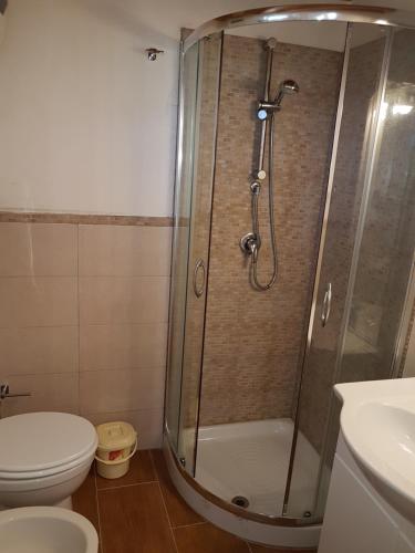 a bathroom with a shower with a toilet and a sink at Suite Panoramic in Porticello