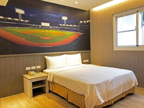 a bedroom with a bed and a baseball game on the wall at La Hotel-Baseball Theme Hall in Kaohsiung