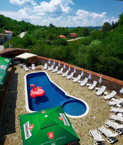 a swimming pool with a red swan in the middle at Yakovtsi Inn in Yakovtsi