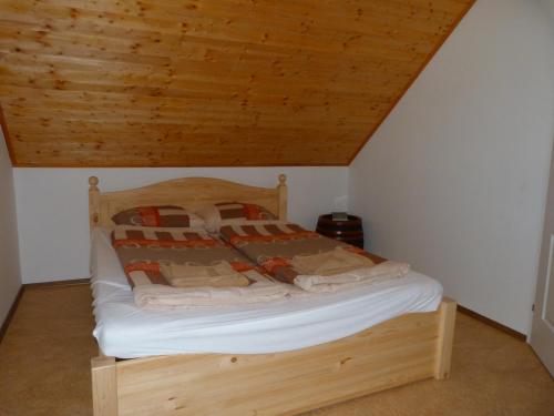 ザマールディにあるIstván Pince Vendégházの木製の天井の客室のベッド1台分です。