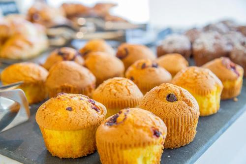 a tray of blueberry muffins on a table at Hotel Mon Cheri in Riccione
