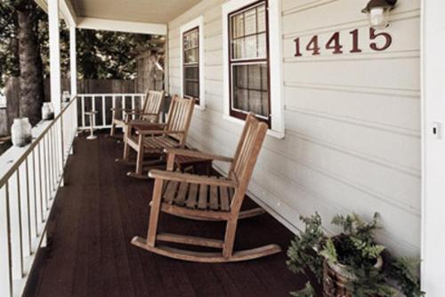 a row of chairs sitting on the porch of a house at Valley Ford Hotel in Valley Ford