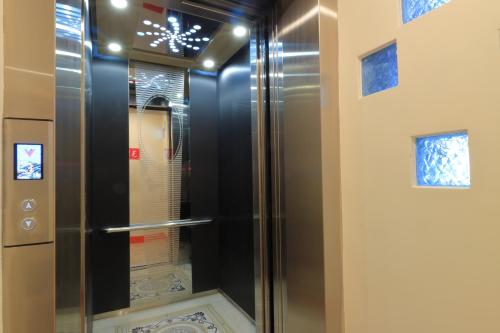 a glass shower in a bathroom with a window at Amir B&B train station & elevator with parking lot in Hualien City
