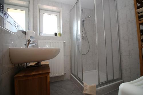 a white bathroom with a sink and a shower at Apartments Gabl in Schönwies