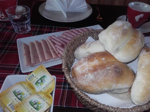 a table with a plate of bread and rolls at apartma "happy Scotts" in Starše