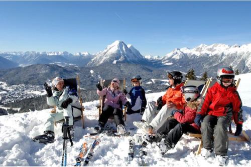 a group of people sitting on top of a snow covered mountain at Seefelds Bed & Breakfast in Seefeld in Tirol