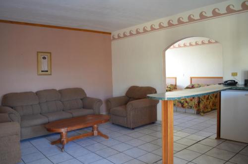 a living room with a couch and a table at Hotel Paraiso in Puerto Peñasco