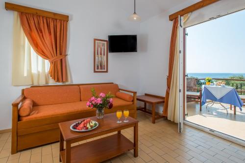 a living room with a couch and a table at Delfinia Hotel & Bungalows in Mithymna