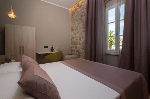 a bedroom with a white bed and a window at Boutique B&B Villa Faggioni in Cavtat