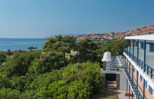 a view of the ocean from the balcony of a building at Delfinia Hotel & Bungalows in Mithymna