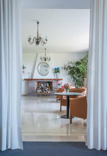 a living room with a table and a fireplace at Delfinia Hotel & Bungalows in Mithymna
