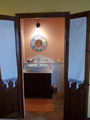 a bathroom with a sink and a mirror at B&B Fonte Dei Billi in Pennabilli