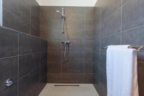 a bathroom with a shower with a white towel at TiaMar in Slatine